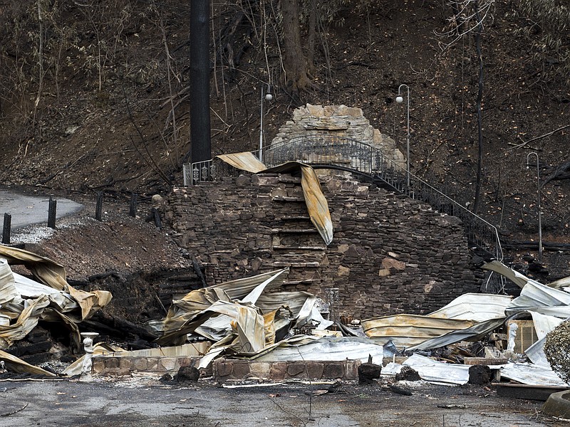 
              This Wednesday, Dec. 7, 2016 photo, shows the remains of Cupid's Chapel of Love, in Gatlinburg, Tenn. Amid deadly wildfires in the Great Smoky Mountains, the city nicknamed “the wedding capital of the south” lost one of its most recognizable places to get hitched. The chapel, a white wood log building with a green tin roof and waterfall around back, hosted about 20,000 weddings over more than two decades. It’s uncertain whether the chapel will ever be rebuilt.  (Andrew Nelles/The Tennessean via AP)
            