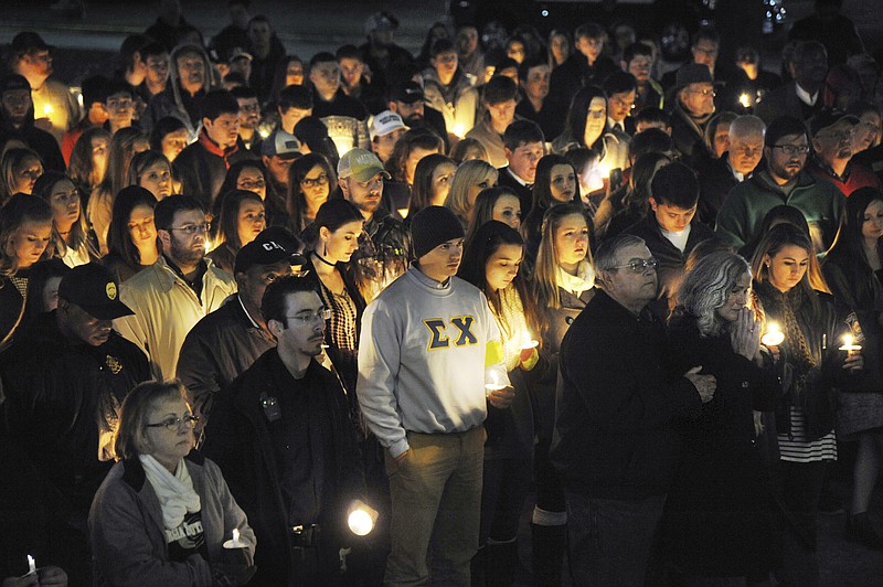 
              Hundreds braved the cold to attend a vigil to show their support for the families of Americus police officer Nicholas Smarr and Georgia Southwestern campus police officer Jody Smith Friday evening, Dec. 9, 2016, in Americus, Ga. Smarr, died after responding to a domestic disturbance call in a Wednesday morning attack. His lifelong friend, university campus Officer Jody Smith, was critically wounded after arriving on the scene as backup to Smarr, and later died from his injuries Thursday.  (Beau Cabell/The Macon Telegraph via AP)
            