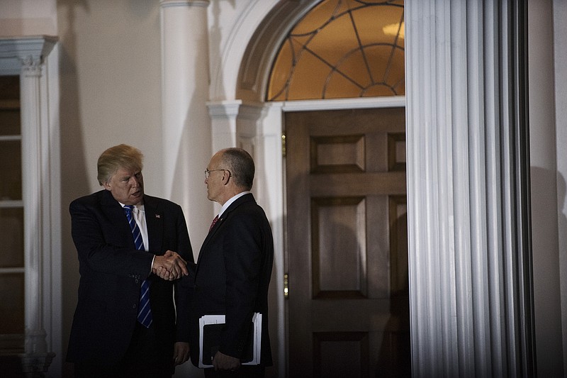 Andy Puzder, the CEO of CKE Restaurants, shakes hands with President-elect Donald Trump after a meeting outside the clubhouse at the Trump National Golf Club in Bedminster, N.J., in mid-November. (Hilary Swift/The New York Times)