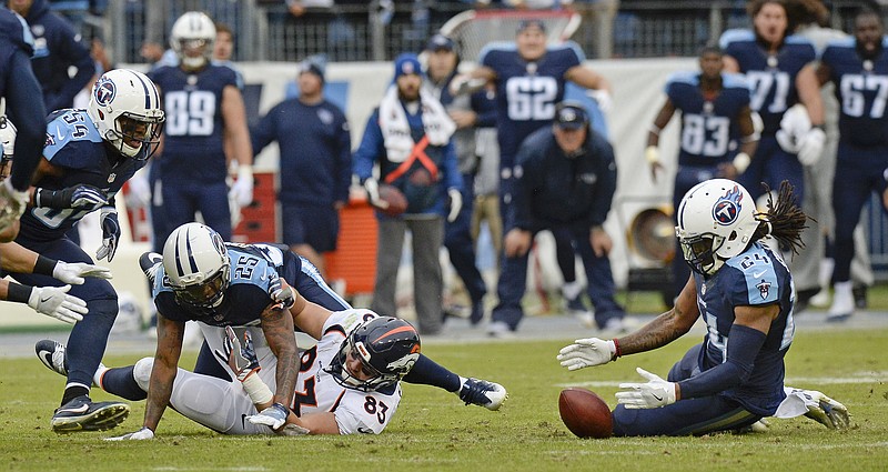 Tennessee Titans safety Daimion Stafford, right, recovers a fumble by Denver Broncos tight end A.J. Derby, left, to end the Broncos' final drive Sunday in Nashville.