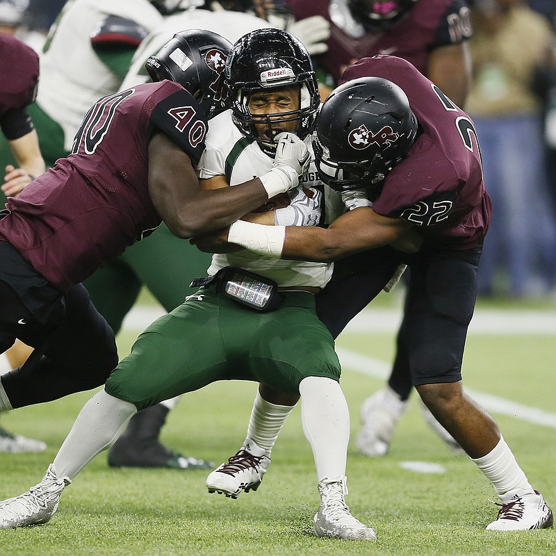 
              FILE - In this file photo made Friday, Dec. 18, 2015, Mansfield Lake Ridge running back Joseph Rowe (44) is tackled by Richmond George Ranch's Toby Ndukwe (40) and Myles Thompson (22) during the Texas UIL 5A Division I state high school championship football game in Houston. Texas is set to launch what state officials call the nation's largest effort to track brain injuries among youth and high school athletes, and hopes to use the data to gauge where rules and equipment changes are improving player safety. (AP Photo/Bob Levey, File)
            