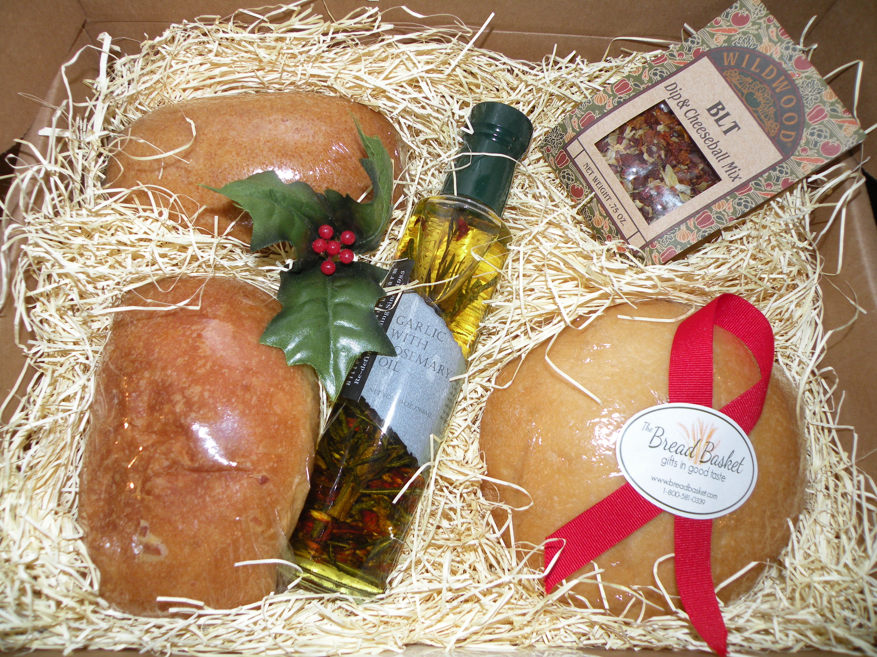 The Double Dipper gift box from the Bread Basket includes gourmet herbal oil, dip and cheese ball mix, wheat-and-cheese mini loaves, and a round sourdough mini loaf.