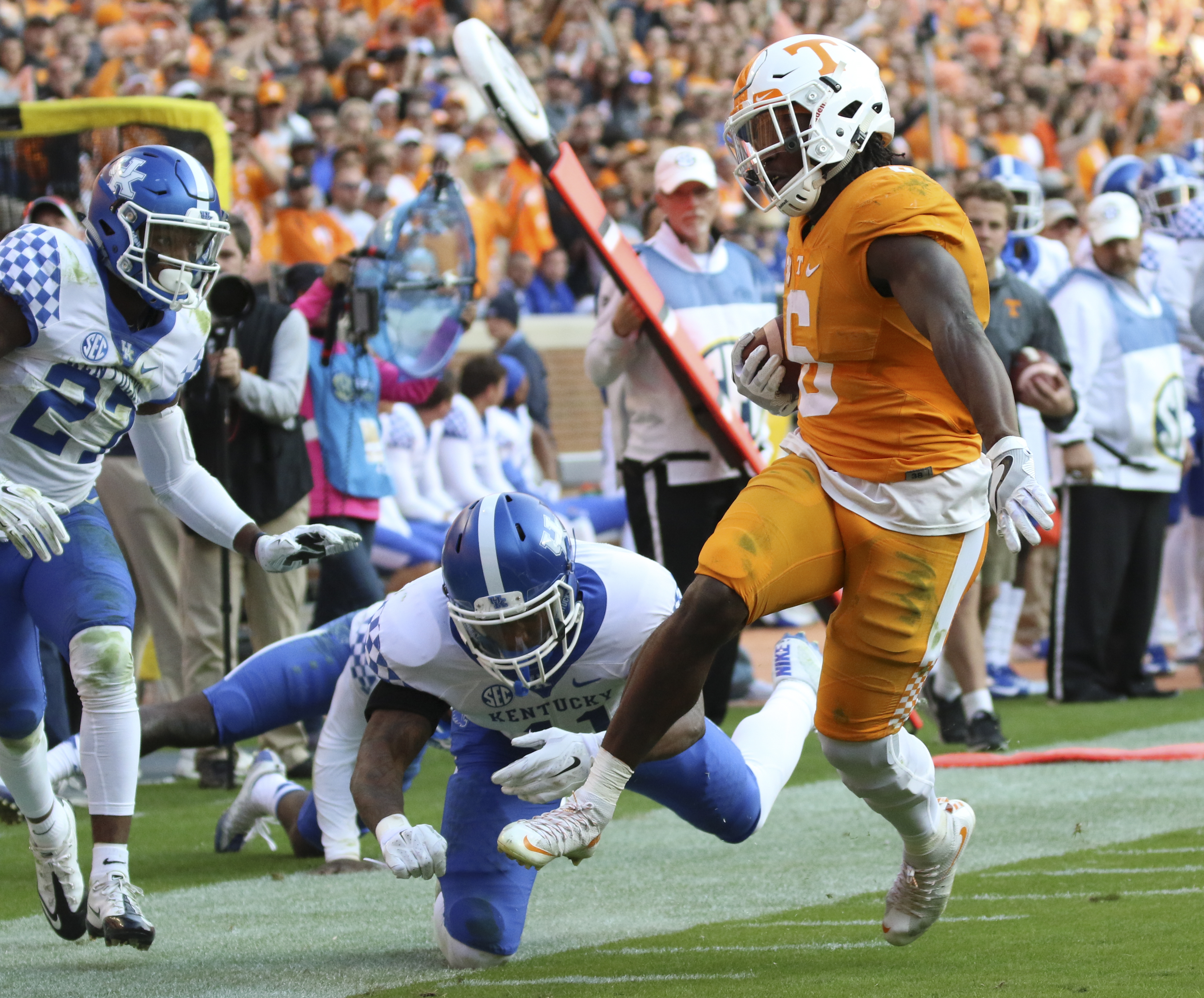 Staff Photo by Dan Henry / The Chattanooga Times Free Press- 11/12/16. Tennessee's Alvin Kamara (6) drops Kentucky's J.D. Harmon (11) to run the ball in for a touchdown during the fourth quarter of play. The Tennessee Volunteers won over the Kentucky Wildcats with a final score of 49-36 at Neyland Stadium in Knoxville, Tenn., on Saturday, November 12, 2016.