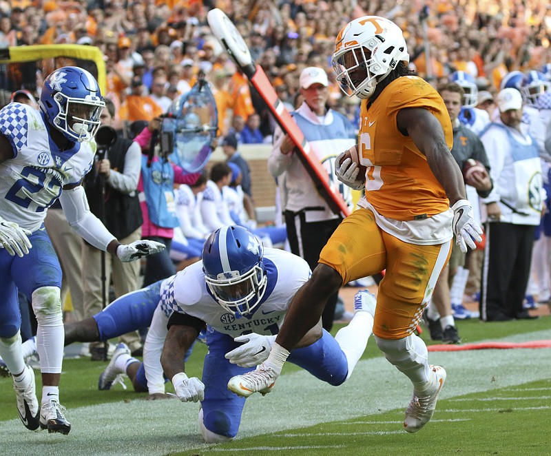 Staff Photo by Dan Henry / The Chattanooga Times Free Press- 11/12/16. Tennessee's Alvin Kamara (6) drops Kentucky's J.D. Harmon (11) to run the ball in for a touchdown during the fourth quarter of play. The Tennessee Volunteers won over the Kentucky Wildcats with a final score of 49-36 at Neyland Stadium in Knoxville, Tenn., on Saturday, November 12, 2016. 