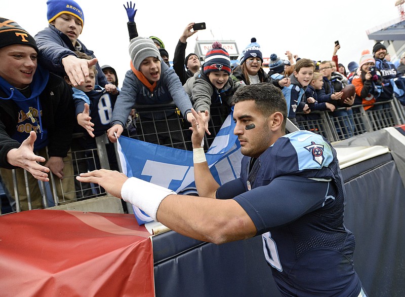 
              Tennessee Titans quarterback Marcus Mariota slaps hands with fans as he leaves the field after an NFL football game against the Denver Broncos Sunday, Dec. 11, 2016, in Nashville, Tenn. The Titans won 13-10.(AP Photo/Mark Zaleski)
            