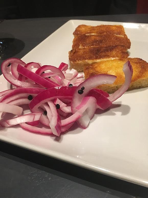For the truest taste of its savory and spicy flavors, sample the onions and toast squares of Robar's havarti cheese toast together. (Staff Photo by Cameron Morgan)