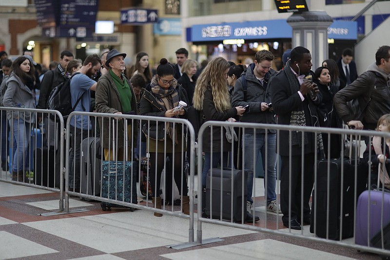 
              Passengers queue up for an express train to Gatwick Airport, running a reduced service as a result of a train strike, in Victoria rail station London, Tuesday, Dec. 13, 2016.  A 48-hour strike starting Tuesday morning has crippled rail services in southern England as a long-running dispute continues to cause misery for hundreds of thousands of commuters in and out of London. (AP Photo/Matt Dunham)
            