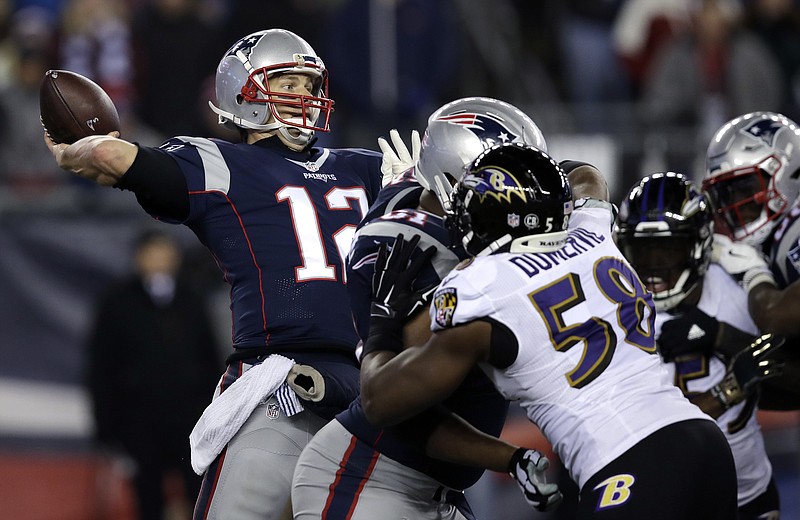 New England Patriots quarterback Tom Brady (12) throws a touchdown pass to Chris Hogan under pressure from Baltimore Ravens linebacker Elvis Dumervil (58) during the fourth quarter of an NFL football game, Monday, Dec. 12, 2016, in Foxborough, Mass.