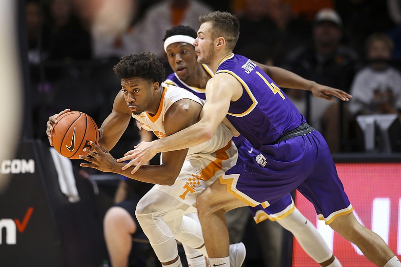 Tennessee senior guard Robert Hubbs III dribbles past Tennessee Tech's Aleksa Jugovic, right, during Tuesday night's game in Knoxville. Hubbs scored 25 points to lead the Vols to a 74-68 victory.