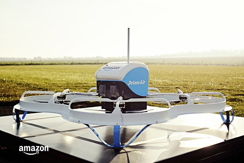 
              This Dec. 7, 2016, photo provided by Amazon shows an Amazon Prime Air drone in Cambridgeshire, United Kingdom. Amazon announced the successful delivery of a package by drone to a customer in Cambridge, U.K., part of a small testing program. With drones, Amazon aims to make deliveries in 30 minutes or less. Packages must weigh five pounds or less and can only be delivered during the day and in clear weather. Amazon plans to expand the trial to hundreds of users. (Amazon via AP)
            