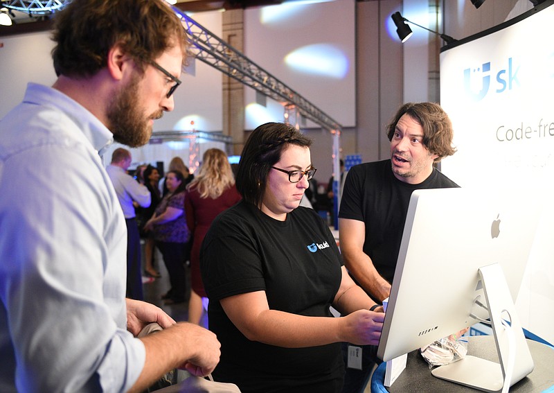 Andy Golden, Patricia Diaz and Charlie Moss, from left, with Skuid, talk during the Spirit of Innovation Awards luncheon and expo Wednesday, Nov. 9, 2016 at the Chattanooga Convention Center.