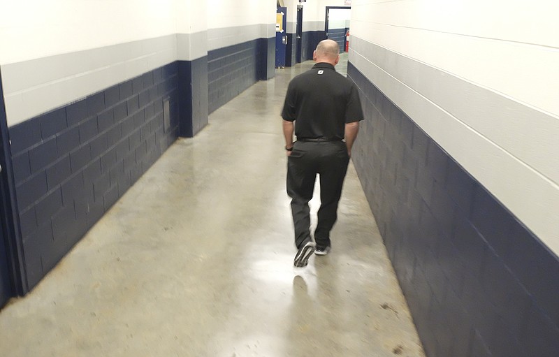 Russ Huesman walks away from his last press conference Thursday at McKenzie Arena.