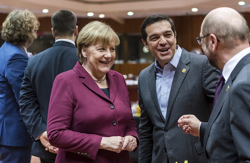 
              German Chancellor Angela Merkel, center, speaks with Greek Prime Minister Alexis Tsipras, second right, and European Parliament President Martin Schulz, right, during a round table meeting at an EU Summit in Brussels on Thursday, Dec. 15, 2016. European Union leaders meet Thursday in Brussels to discuss defense, migration, the conflict in Syria and Britain's plans to leave the bloc. (AP Photo/Geert Vanden Wijngaert)
            