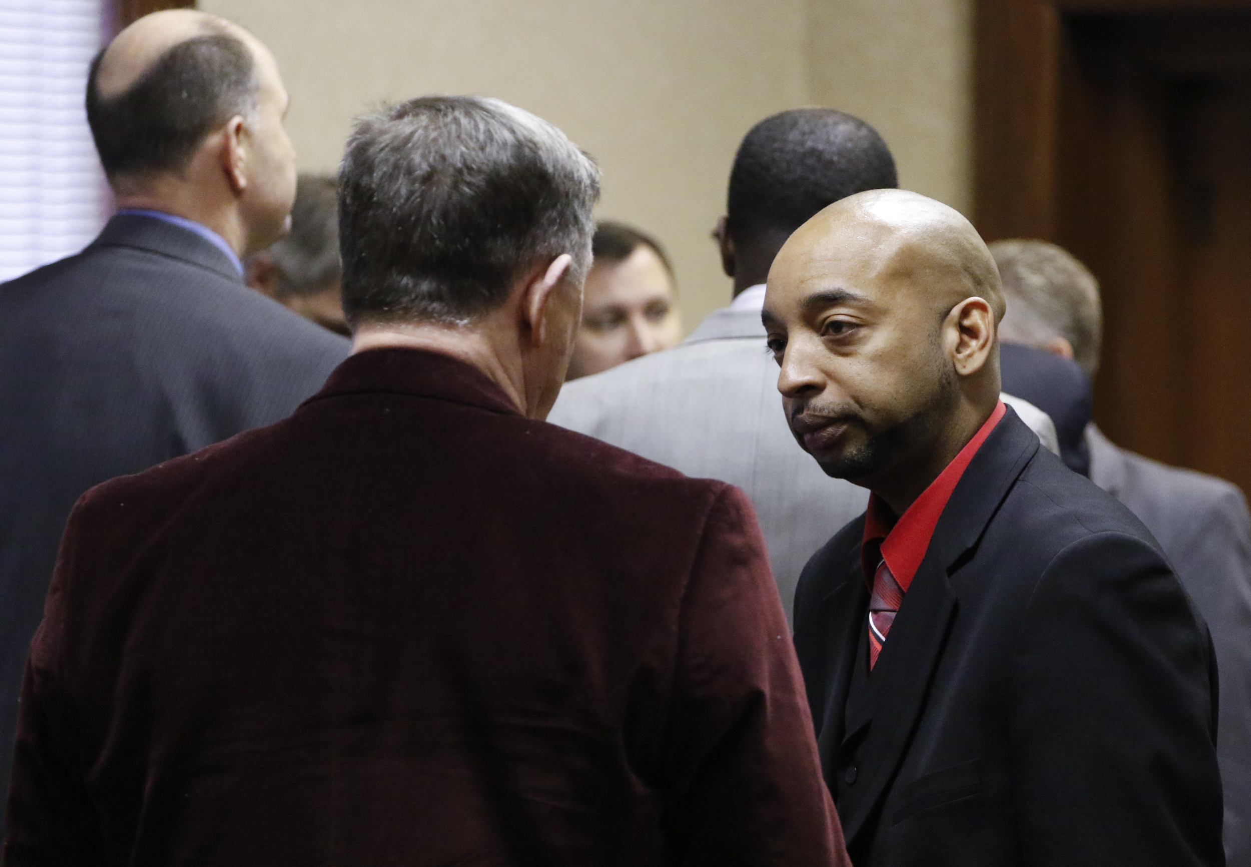 Staff Photo by Dan Henry / The Chattanooga Times Free Press- 2/15/16. Ooltewah High School head basketball coach Andre "Tank" Montgomery converses with people in the courtroom during a brief intermission in Hamilton County Juvenile Court on February 25, 2016. Hamilton County District Attorney Neal Pinkston charged head coach Andre "Tank" Montgomery, assistant coach Karl Williams and Athletic Director Allard "Jesse" Nayadley with failing to report child abuse or suspected child sexual abuse in connection with the rape of an Ooltewah High School freshman by his basketball teammates Dec. 22, 2015.