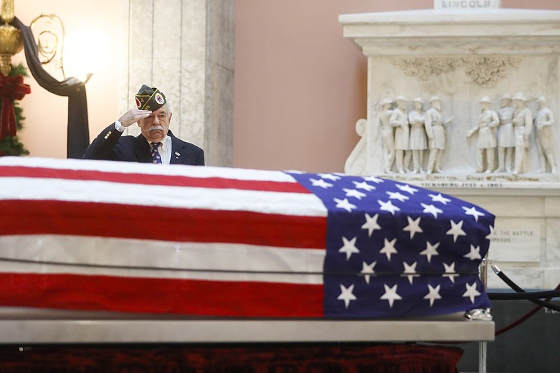 Warren Motts salutes the casket of the John Glenn as Glenn lies in repose, Friday, Dec. 16, 2016, in Columbus, Ohio. Glenn's home state and the nation began saying goodbye to the famed astronaut as he lies in state at Ohio's capitol building. Glenn, 95, the first American to orbit Earth, died last week. (AP Photo/John Minchillo)

