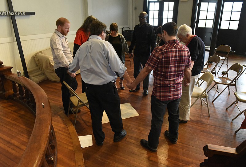 Staff Photo by John Rawlston Participants join hands in prayer after a worship service at the Mercy Junction Justice and Peace Center at St. Andrews in the Highland Park community on Sunday, Sept. 13, 2015, in Chattanooga, Tenn.