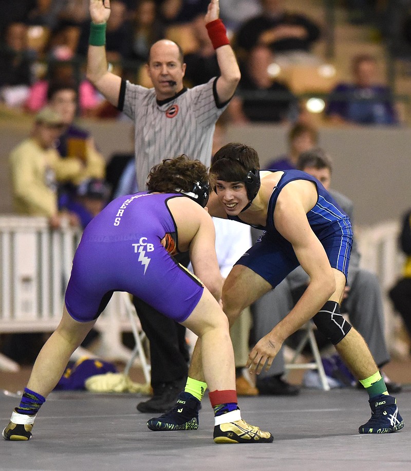 McCallie's Judah Duhm (right) looks for an opening against Christian Brother's Tommy Bracket in the 160 pound class.  Duhm won the match.  The finals of the TSSAA State Wrestlings Championships were held at the Williamson Agricultural Center in Franklin, Tn. on February 20, 2016.