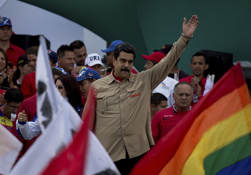 
              Venezuela's President Nicolas Maduro greets supporters upon his arrival to a rally at Bolivar Avenue in Caracas, Venezuela, Saturday, Dec. 17, 2016. Maduro called for a pro-government rally as the country to give a tribute to the Venezuelan hero Simon Bolivar meanwhile the country is on edge over his so-far failed plan to introduce larger-denominated bills to fight soaring inflation. (AP Photo/Fernando Llano)
            