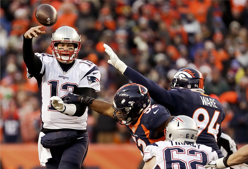 
              New England Patriots quarterback Tom Brady passes under pressure against the Denver Broncos during the second half of an NFL football game Sunday, Dec. 18, 2016, in Denver. (AP Photo/Jack Dempsey)
            