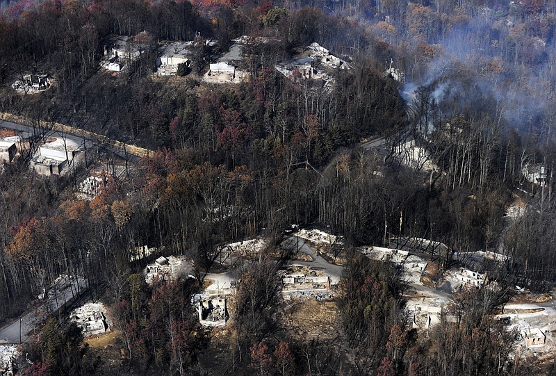 Smoke rises from destroyed homes, many burned down to the foundation, the day after a wildfire hit Gatlinburg Nov. 29. The fires in Gatlinburg ultimately spread to over 17,000 acres and destroyed thousands of homes and businesses.