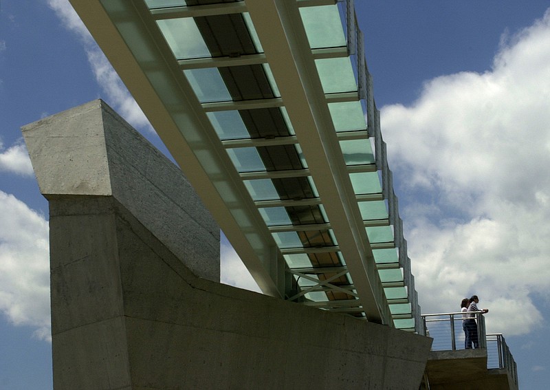 The iconic glass in the Holmberg Bridge between Walnut Street and the Bluff View Art District soon will be no more.