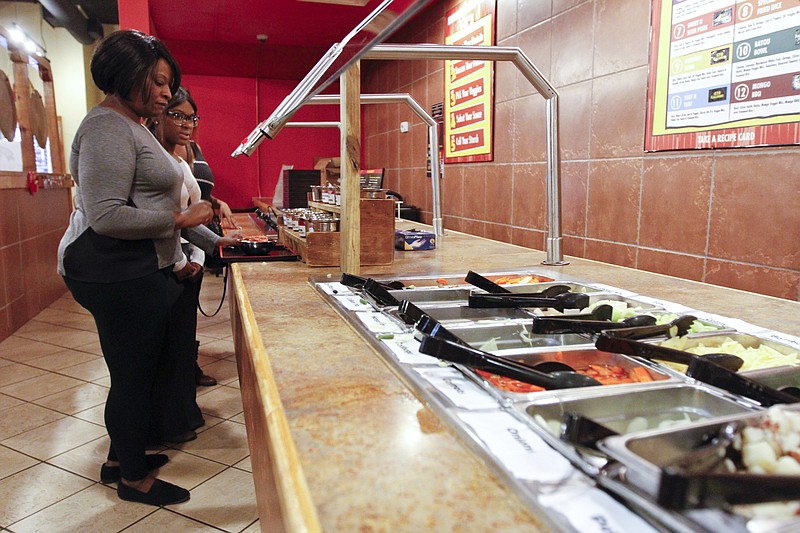 Felicia Jackson eats lunch at downtown Chattanooga's Genghis Grill.