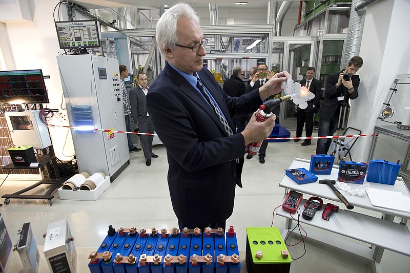 
              Company HE3DA President Jan Prochazka shows qualities of a new battery during the  official start of a battery production line in Prague, on Monday, Dec. 19, 2016. The new battery is based on nanotechnology and is supposed to be be more efficient, long-lasting, cheaper, lighter and above all safer. The battery is designed to store energy from renewable electric sources and cooperate with smart grids. Next planned type will be suitable for electric cars. (Michal Kamaryt /CTK via AP)
            