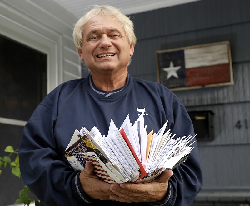 
              Rex Teter, a member of the Electoral College, holds two days of delivered mail at his home in Pasadena, Texas, Tuesday, Dec. 13, 2016. And you thought Election Day was in November. Electors are gathering in every state Dec, 19, to formally elect Donald Trump president even as anti-Trump forces try one last time to deny him the White House. Republican electors say they have been deluged with emails, phone calls and letters urging them not to support Trump. Many of the emails are part of coordinated campaigns. (AP Photo/David J. Phillip)
            