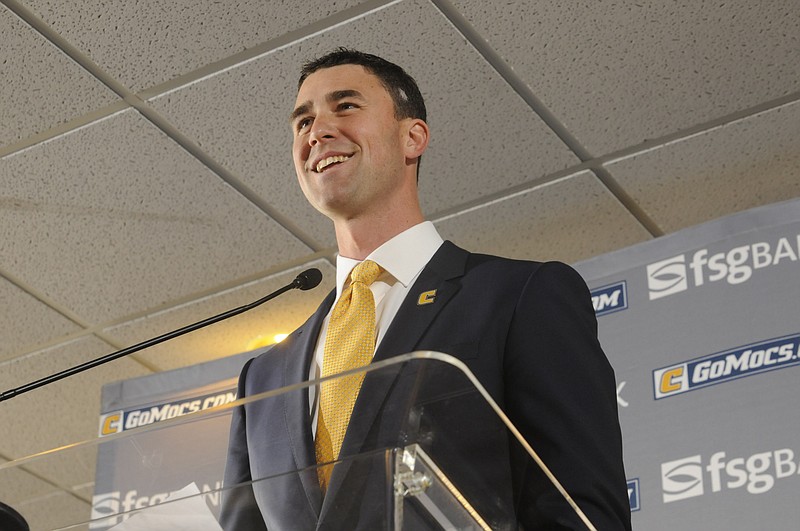 Tom Arth speaks to fans, the media and attending players as the new Chattanooga Mocs head football coach Tuesday inside the Stadium Club at Finley Stadium.