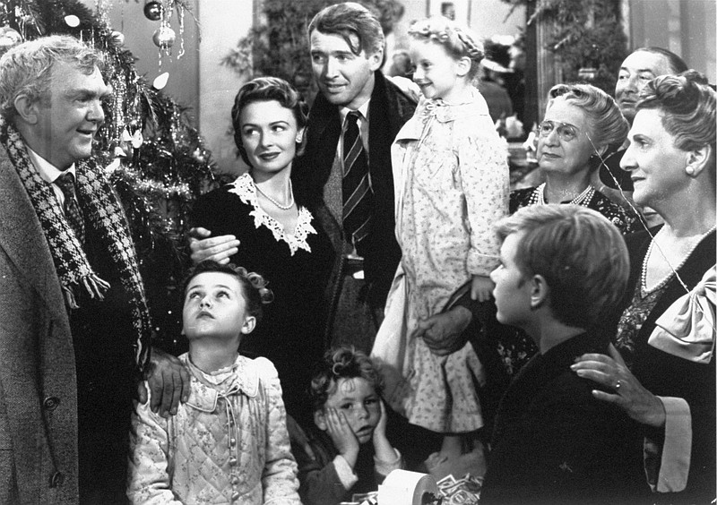 James Stewart as George Bailey, center, is reunited with his wife, played by Donna Reed, third from left, and family during the last scene of Frank Capra's "It's a Wonderful Life."