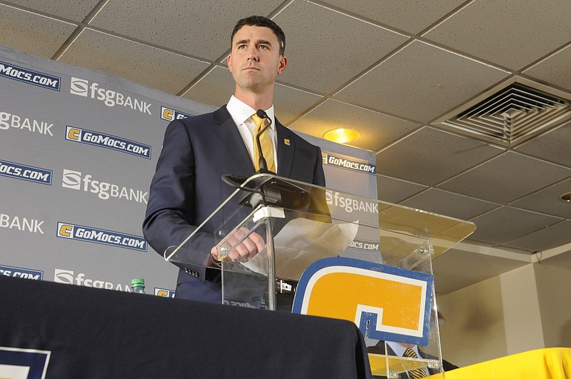 Tom Arth listens to a question by the media on Tuesday inside the Stadium Club at Finley Stadium.