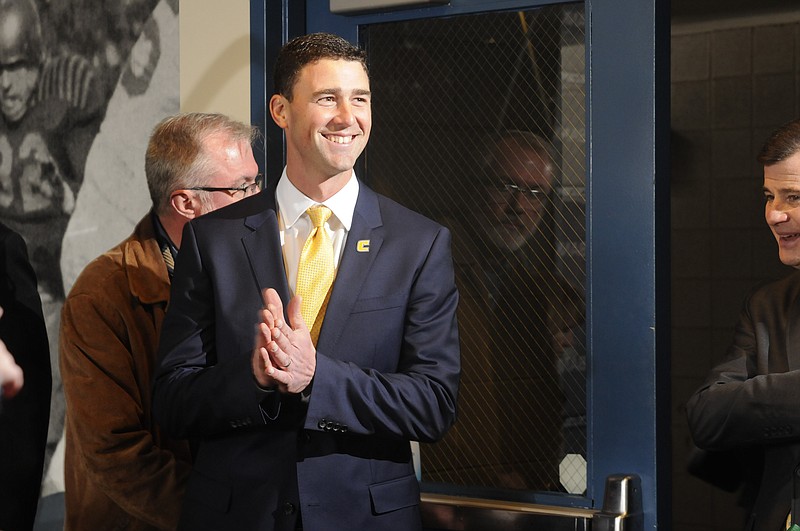 Tom Arth enters the Stadium Club Tuesday to speak to fans, the media and attending players for the first meeting as the new Chattanooga Mocs head football coach midday at Finley Stadium.