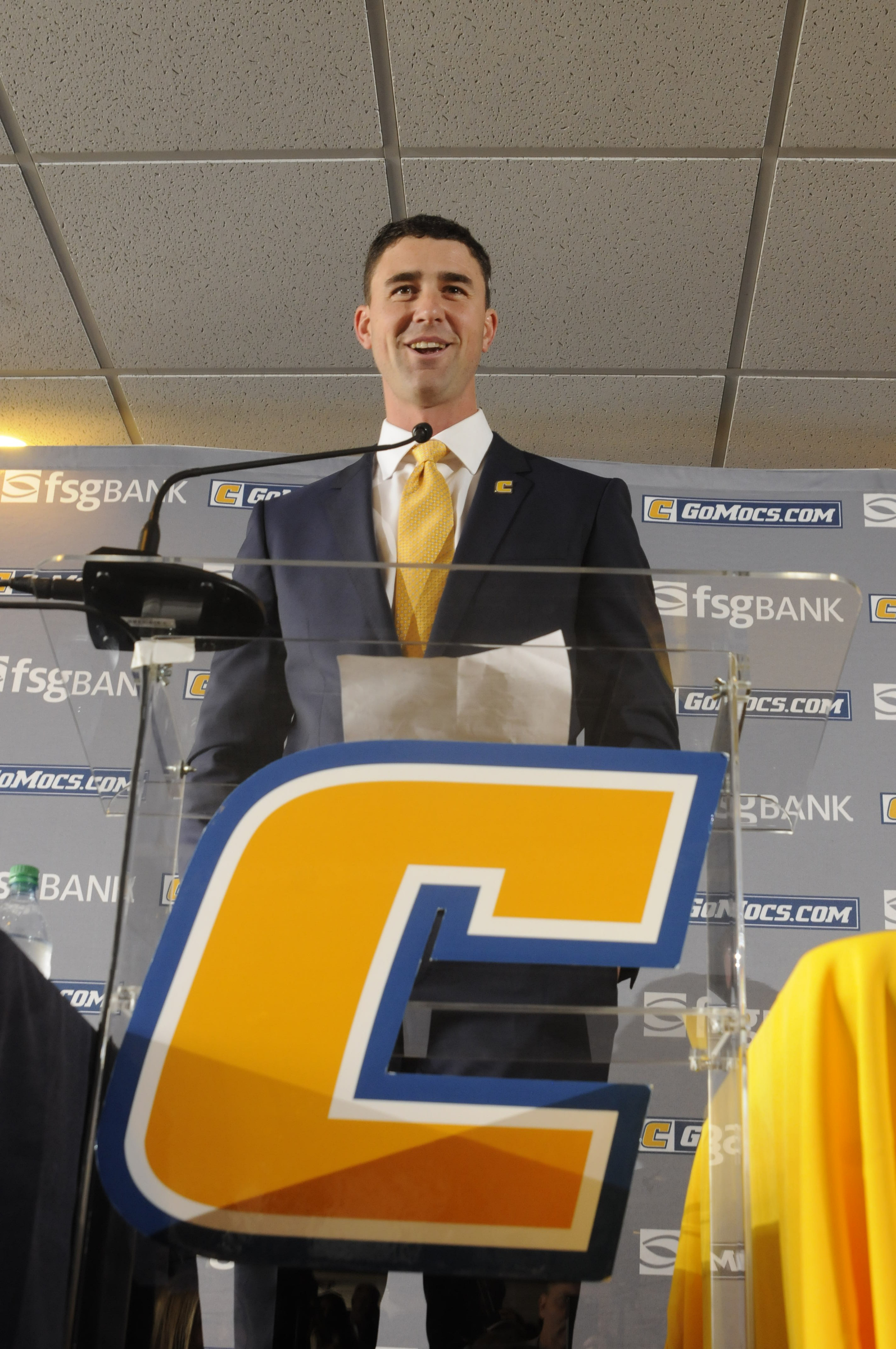 Tom Arth speaks to fans, the media and attending players as the new Chattanooga Mocs head football coach Tuesday inside the Stadium Club at Finley Stadium.