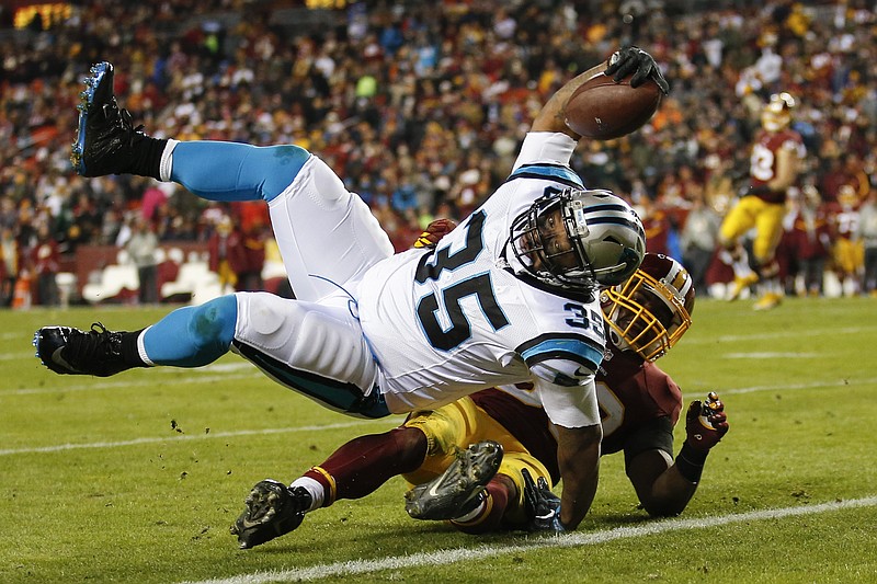 Carolina Panthers fullback Mike Tolbert (35) rolls over Washington Redskins outside linebacker Martrell Spaight (50) for a touchdown during the second half of an NFL football game in Landover, Md., Monday, Dec. 19, 2016. (AP Photo/Alex Brandon)