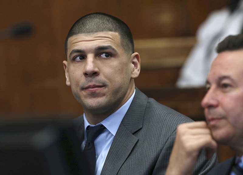 
              Former New England Patriots NFL football player Aaron Hernandez appears with defense attorney Jose Baez during a hearing at Suffolk Superior Court, Tuesday, Dec, 20, 2016, in Boston. Hernandez, who is serving a life sentence for the 2013 killing of Odin Lloyd, is charged in the 2012 slayings of two men outside a Boston nightclub. (Angela Rowlings/The Boston Herald via AP, Pool)
            
