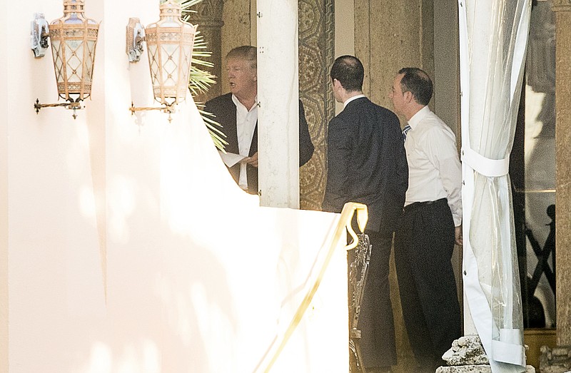 President-elect Donald Trump, left, Stephen Miller, a senior adviser to President-elect Donald Trump, second from right, and Chief of Staff Reince Priebus, right, speak at Mar-a-Lago resort, where Trump is taking meetings, in Palm Beach, Fla., Monday, Dec. 19, 2016. (AP Photo/Andrew Harnik)