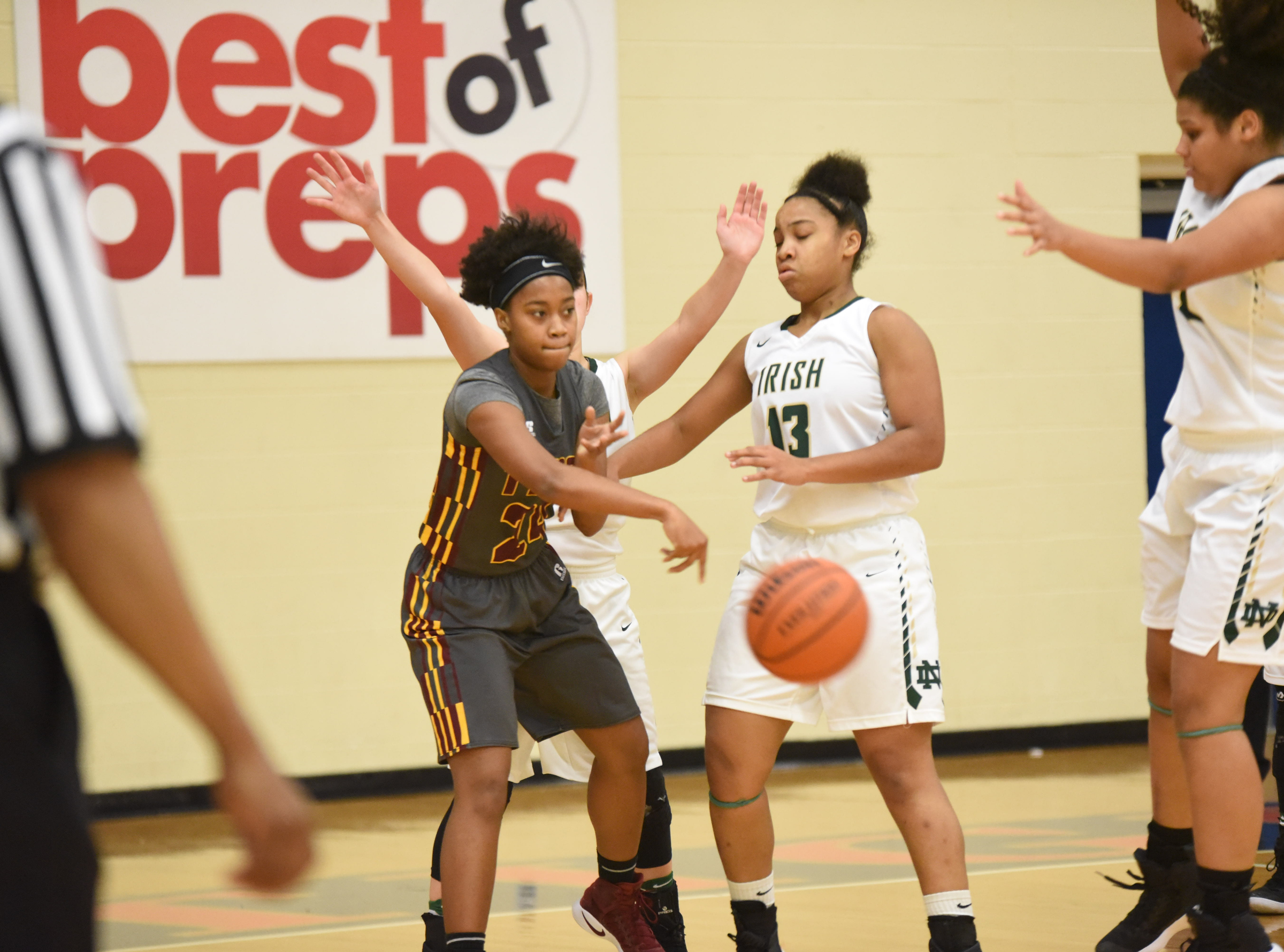 Tyner's Keionna McCutheon (24) passes the ball out front after running into defense from Notre Dame's Jada Sims (13) Wednesday during first round action in the Times Free Press Best of Preps basketball tournament at Chattanooga State.