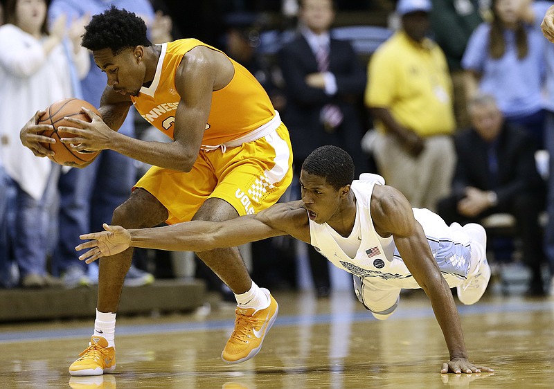 Tennessee's Jordan Bowden, left, holds on to the ball as North Carolina's Kenny Williams, right, dives for it during their game this month in Chapel Hill. Bowden has faced more defensive attention after a hot stretch, and his statistics have taken a hit.