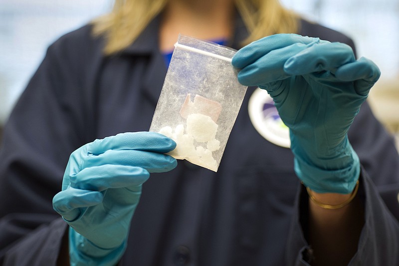 
              In this Aug. 9, 2016, photo, a bag of 4-fluoroisobutyrylfentanyl, which was seized in a drug raid, is displayed at the Drug Enforcement Administration (DEA) Special Testing and Research Laboratory in Sterling, Va. A novel class of deadly drugs is exploding across the country, with many manufactured in China for export around the world. The drugs, synthetic opioids, are fueling the deadliest addiction crisis the U.S. has ever seen. (AP Photo/Cliff Owen)
            