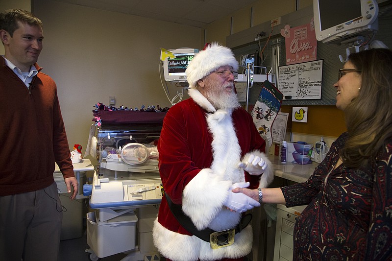 
              Margaret Baudinet, right, is congratulated on the birth of her quintuplets by Santa Claus, Wednesday, Dec, 21, 2016, at the St. Joseph's Nursery Intensive Care Unit in Phoenix. Looking on is Margaret's husband, Michael Baudinet. Margaret Baudinet gave birth on Dec. 4 to four girls and one boy. (Mark Henle/The Arizona Republic via AP)
            