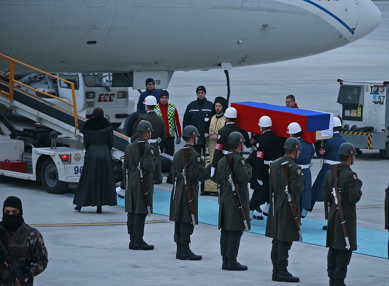 Members of a Turkish forces honour guard carry the Russian flag-draped coffin of Russian Ambassador to Turkey Andrei Karlov who was assassinated Monday, toward a plane to be carried home, during a ceremony at the airport in Ankara, Turkey, Tuesday, Dec, 20, 2016. Turkey and Russia are more committed than ever to advance peace efforts in Syria, the two countries' foreign ministers declared Tuesday, a day after the killing in an attack both countries described as an attempt to disrupt their improved ties. (AP Photo/Emrah Gurel)