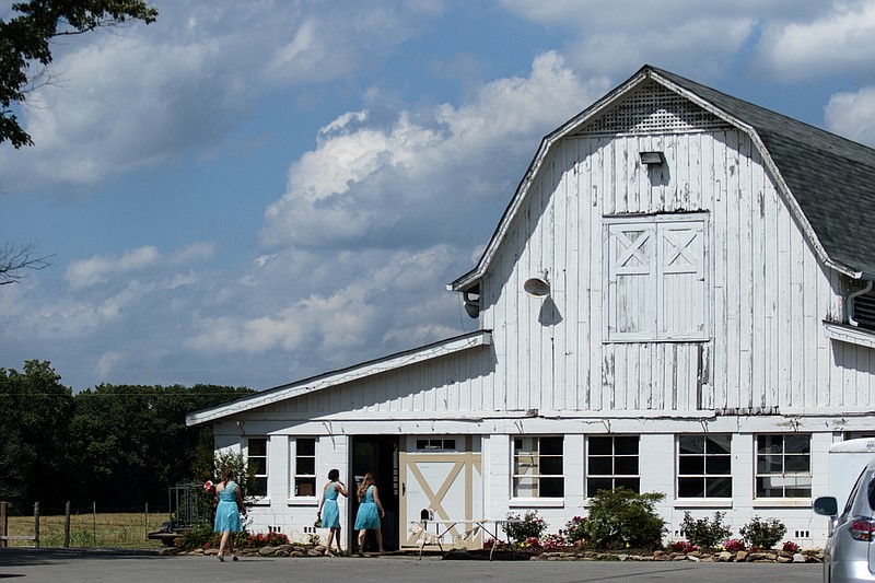 A wedding party enters the barn at Mountain Cove Farms in this 2015 photo.
