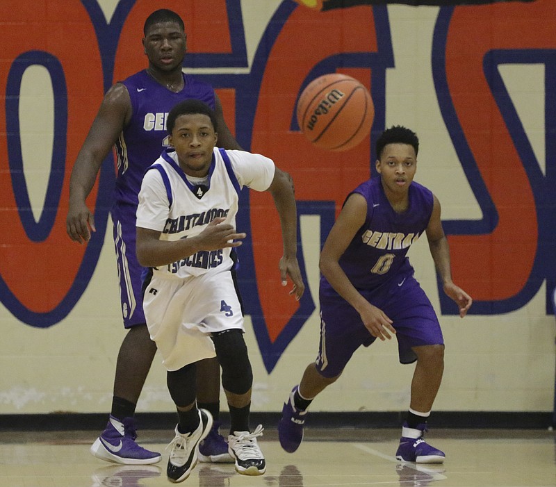 Staff Photo by Dan Henry / The Chattanooga Times Free Press- 12/22/16. CSAS's Darius Graves (14) and Central's Cavonte McKibbens (0) chase a loose ball during the Best of Preps tournament on December 22, 2016 being held at Chattanooga State. CSAS won over Central with a final score of 53-50.