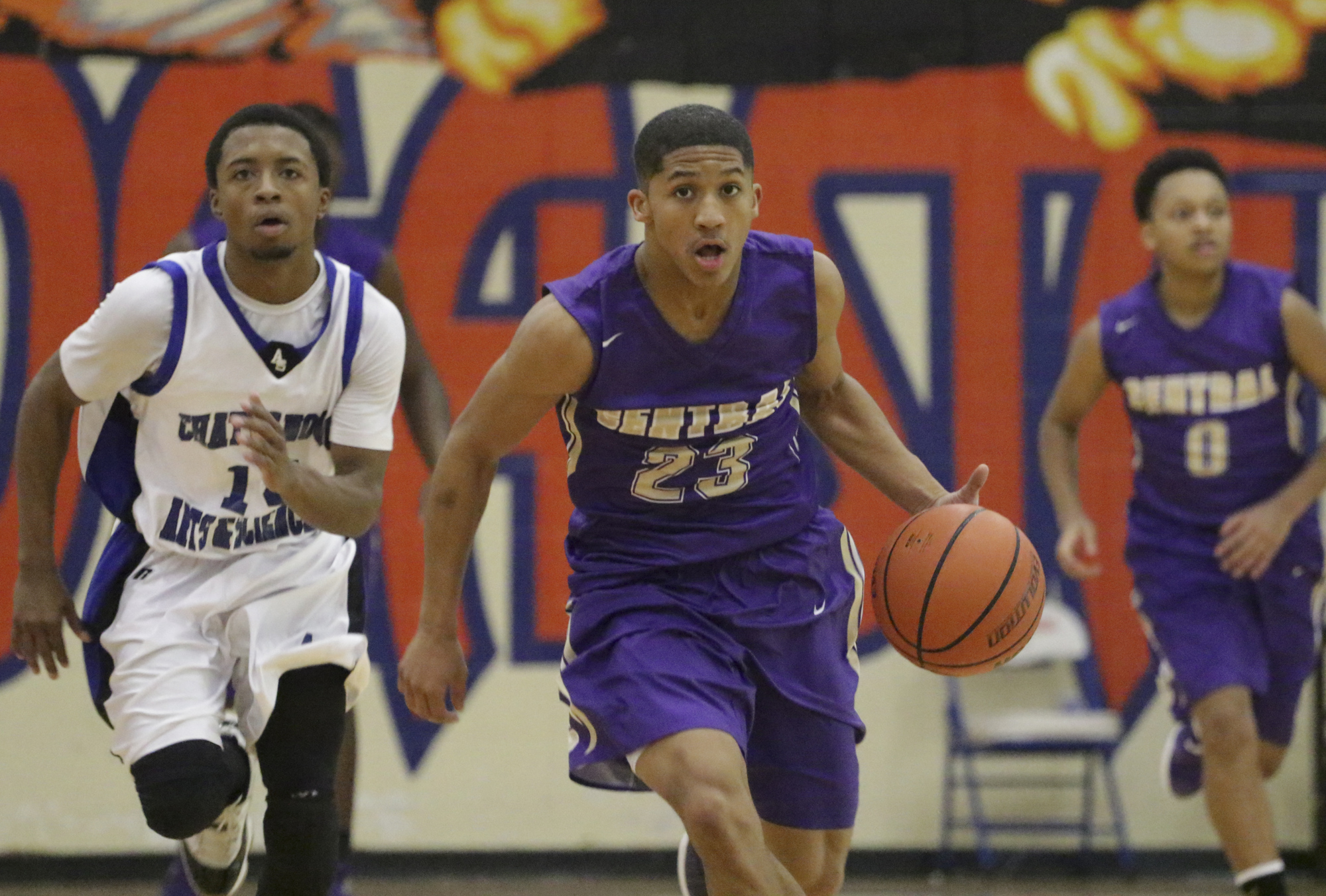 Arts & Sciences' Darius Graves, left, chases Central's Gavin Spotts as he heads toward the basket during a consolation-bracket game at the Times Free Press Best of Preps basketball tournament Thursday at Chattanooga State.