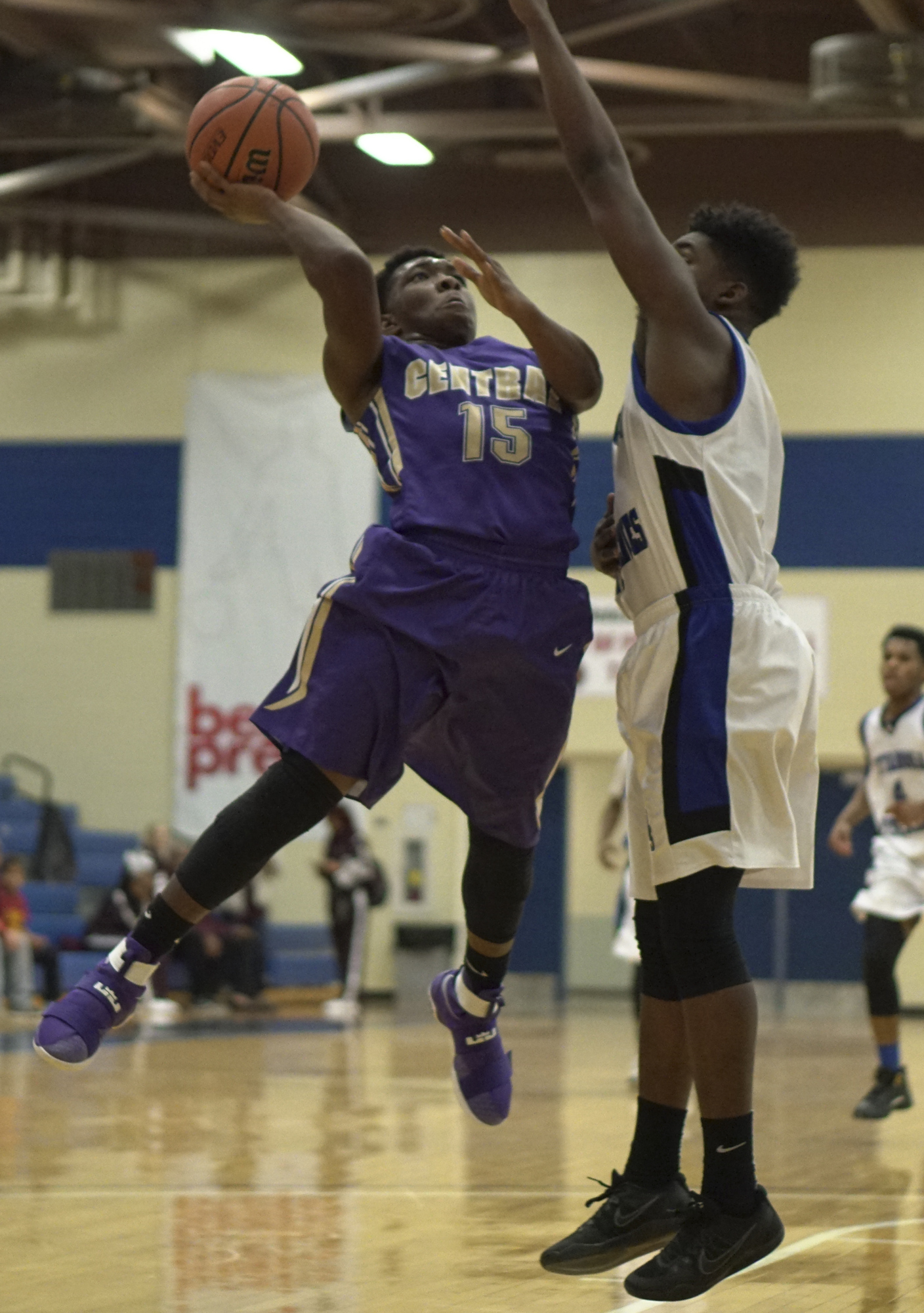 Staff Photo by Dan Henry / The Chattanooga Times Free Press- 12/22/16. CSAS's Paris Sterling (11) defends as Central's Julius Jackson (15) shoots during the Best of Preps tournament on December 22, 2016 being held at Chattanooga State. CSAS won over Central with a final score of 53-50.