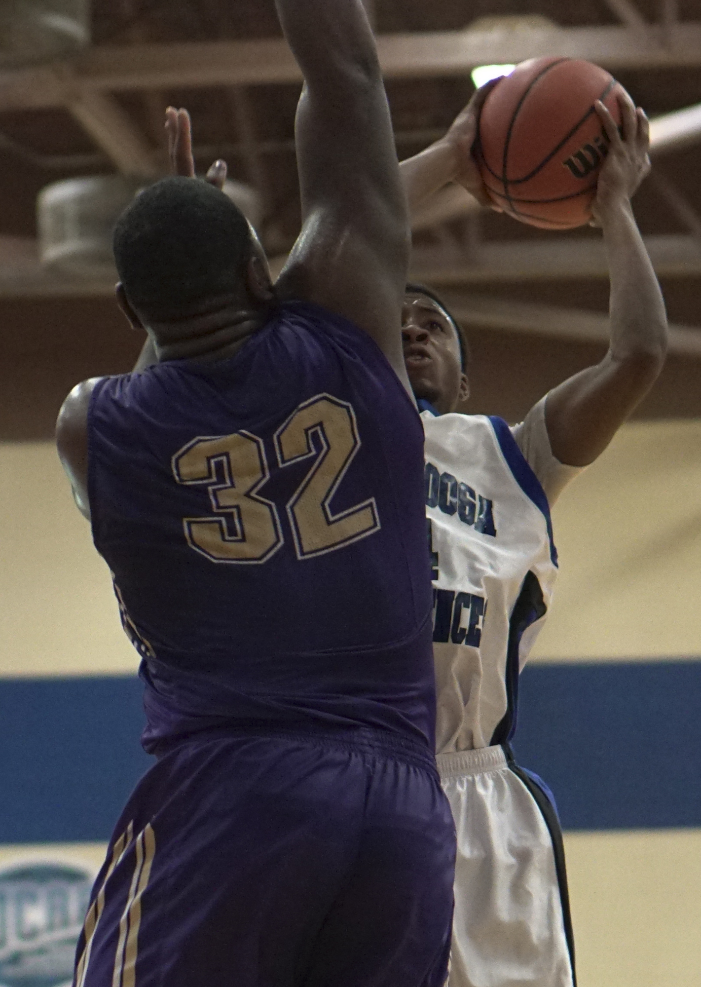 Staff Photo by Dan Henry / The Chattanooga Times Free Press- 12/22/16. CSAS's Darius Graves (14) shoots asCentral's McClendon Curtis (32) defends during the Best of Preps tournament on December 22, 2016 being held at Chattanooga State. CSAS won over Central with a final score of 53-50.