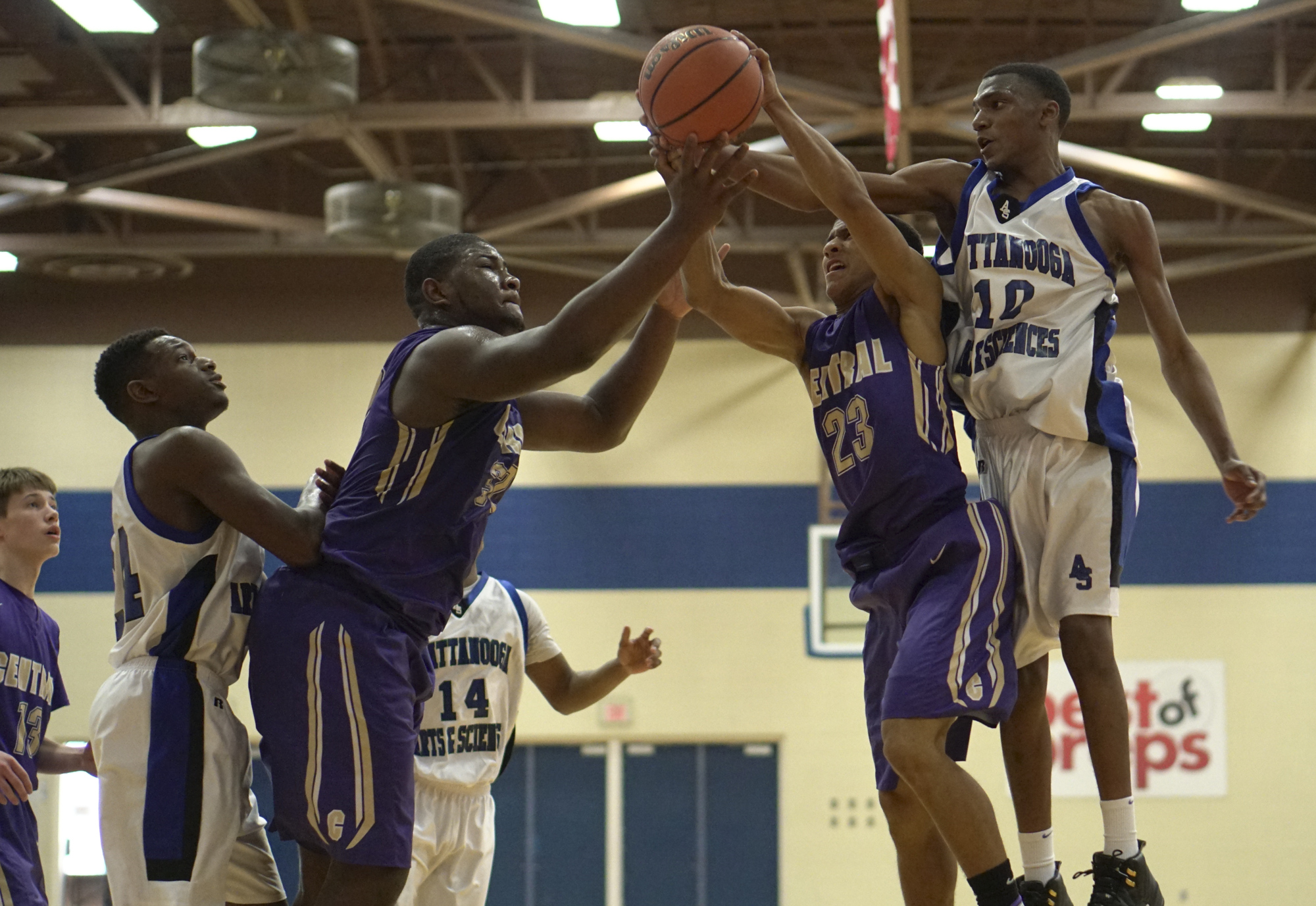 Staff Photo by Dan Henry / The Chattanooga Times Free Press- 12/22/16. CSAS's Darius Graves (14), Central's McClendon Curtis (32), Central's Gavin Spotts (23) and CSAS's Jameel Dodds (10) battle for possession of the ball during the Best of Preps tournament on December 22, 2016 being held at Chattanooga State. CSAS won over Central with a final score of 53-50.