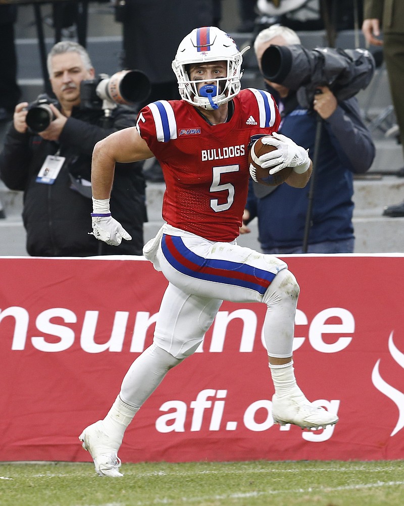 
              Louisiana Tech wide receiver Trent Taylor runs for a touchdown against Navy during first half of the Armed Forces Bowl NCAA college football game, Friday, Dec. 23, 2016, in Fort Worth, Texas. (AP Photo/Jim Cowsert)
            