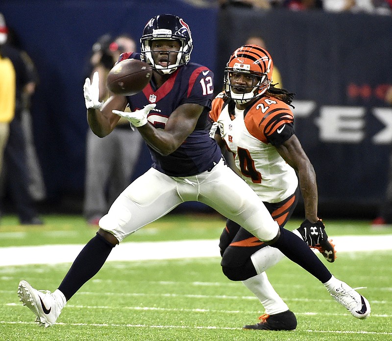 
              Houston Texans' Keith Mumphery (12) catches a pass as Cincinnati Bengals' Adam Jones (24) defends during the second half of an NFL football game Saturday, Dec. 24, 2016, in Houston. (AP Photo/Eric Christian Smith)
            