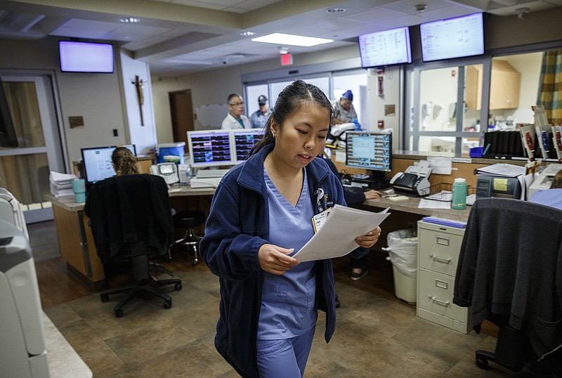 Medical scribe Lynn Tran checks medical records for a patient at CHI Memorial's Hixson emergency room on Friday, Dec. 23, 2016, in Chattanooga, Tenn.